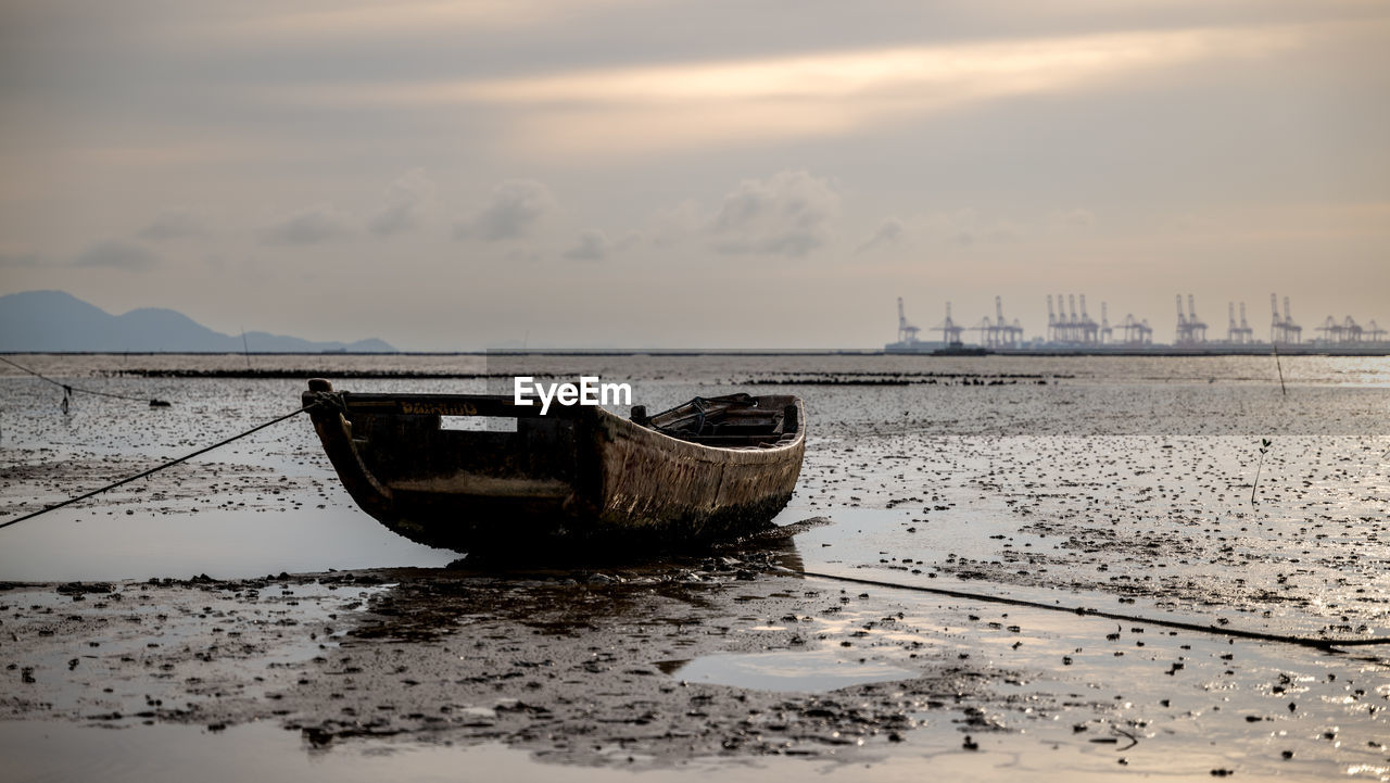 water, morning, nautical vessel, sky, sea, shore, reflection, transportation, nature, wave, ocean, beach, mode of transportation, cloud, coast, land, boat, vehicle, no people, ship, scenics - nature, horizon, moored, tranquility, outdoors, beauty in nature, environment, travel, tranquil scene, watercraft, sand, travel destinations, landscape, day, architecture, abandoned