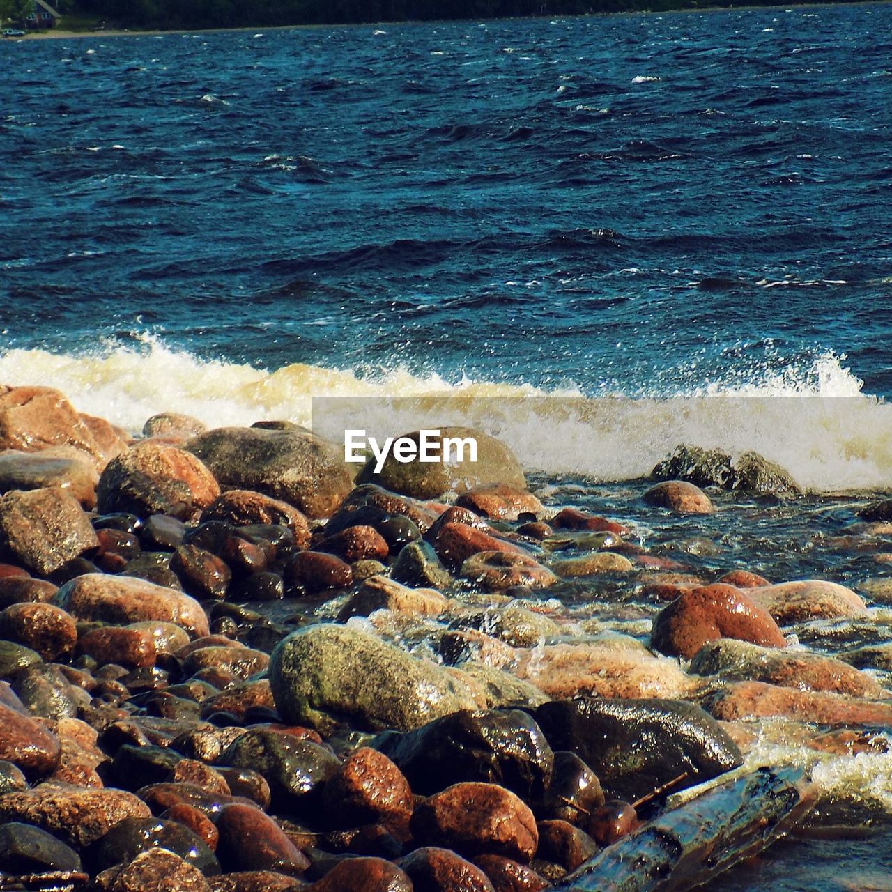 SCENIC VIEW OF SEA WITH ROCKS IN BACKGROUND