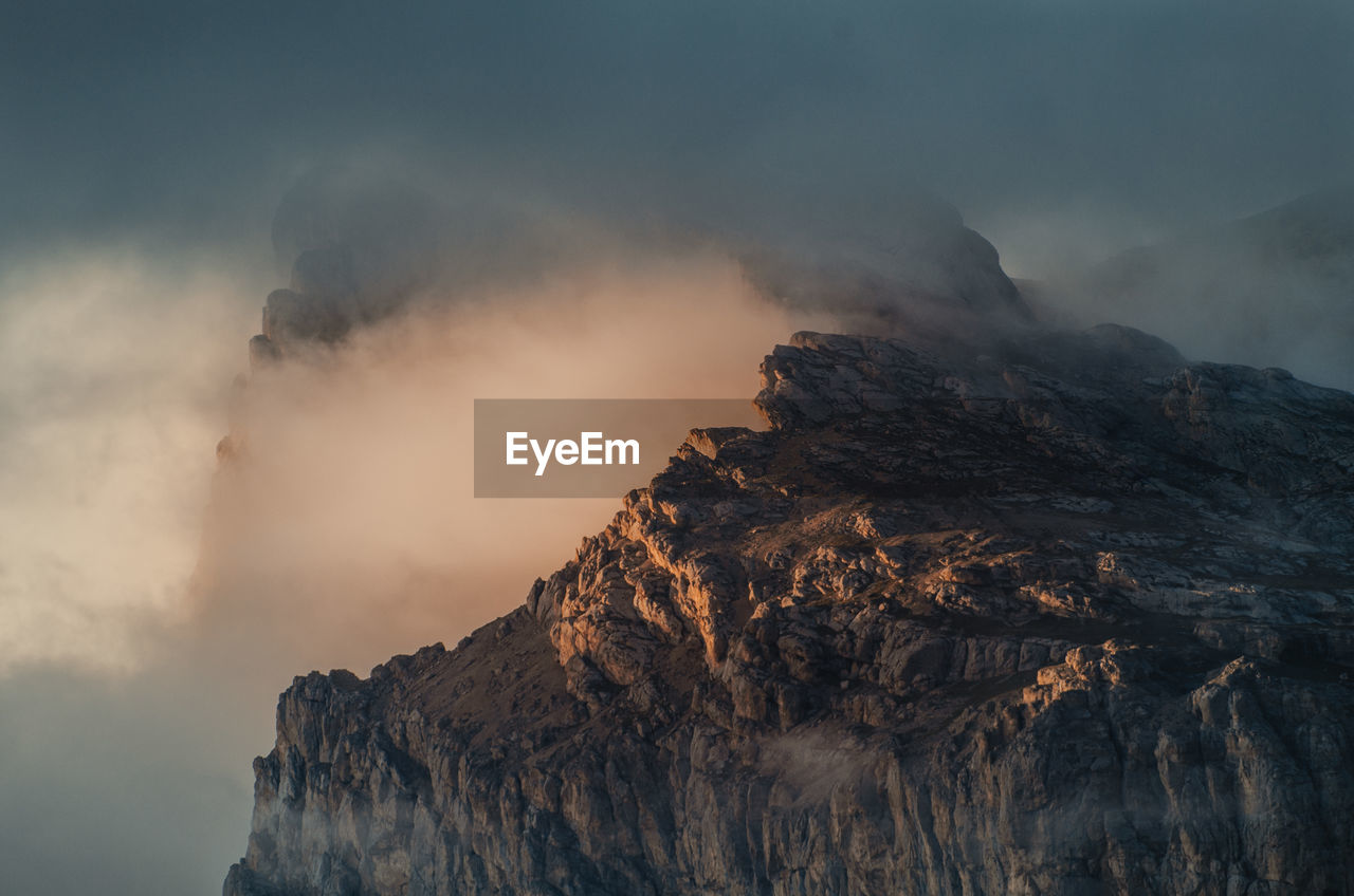 Smoke emitting from volcanic mountain against sky