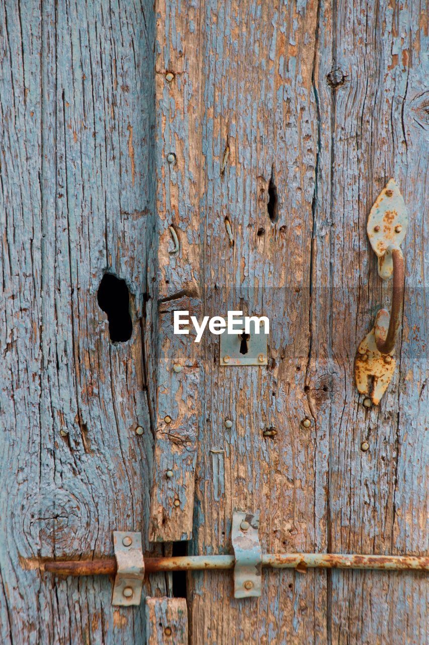 Full frame shot of weathered locked door