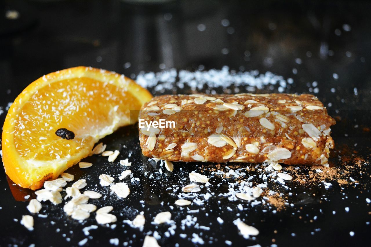 Close-up of orange slice with granola bar