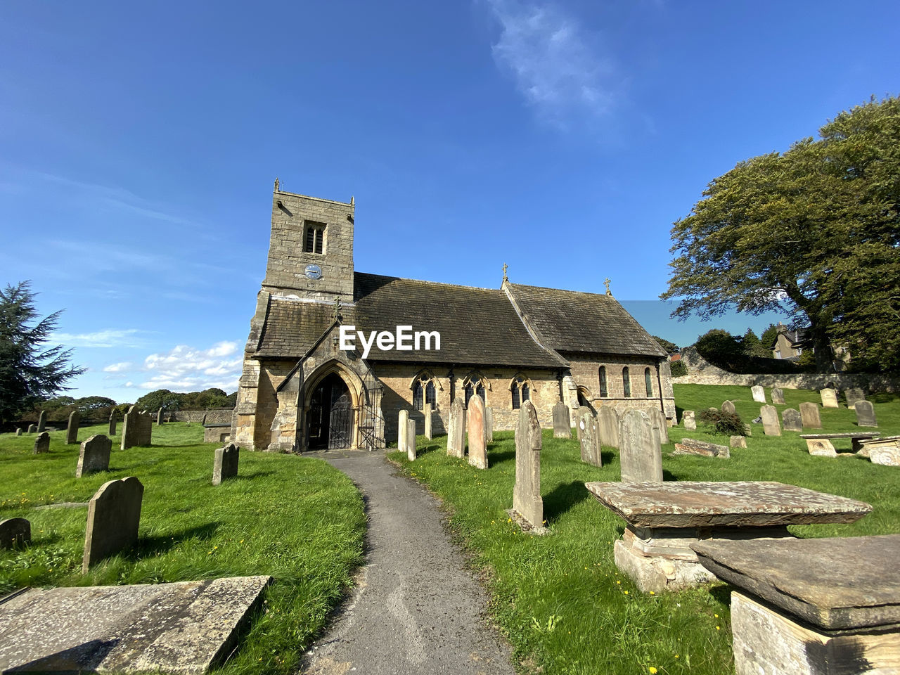 An old church on, stang lane, set against a vivid blue sky in, farnham, harrogate, uk