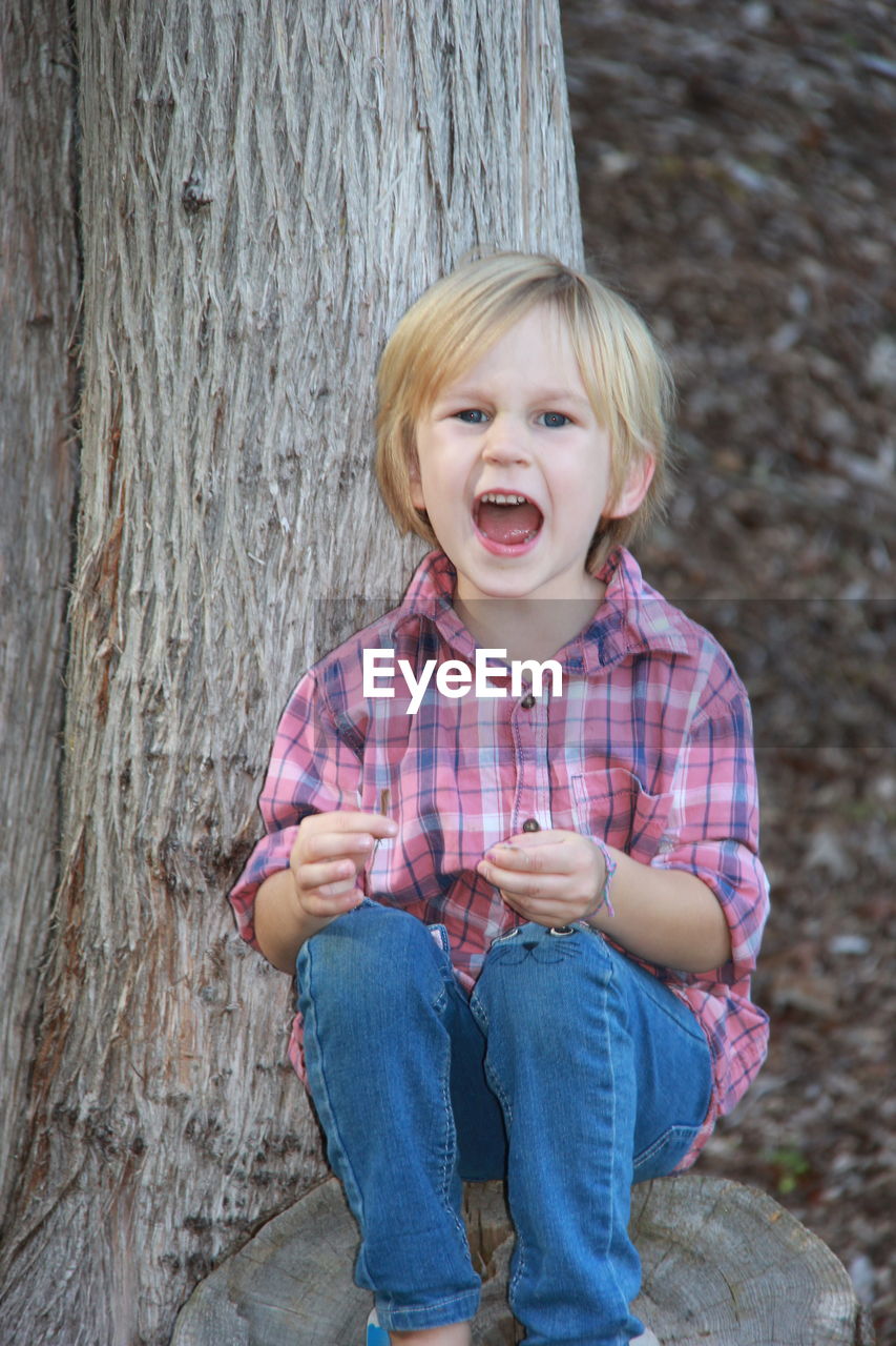 PORTRAIT OF A SMILING BOY IN MOUTH