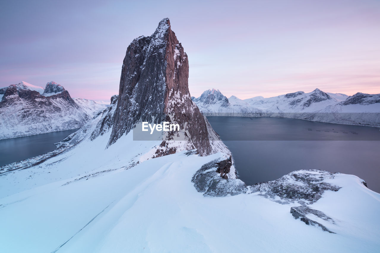 SNOW COVERED MOUNTAIN AGAINST SKY DURING SUNSET