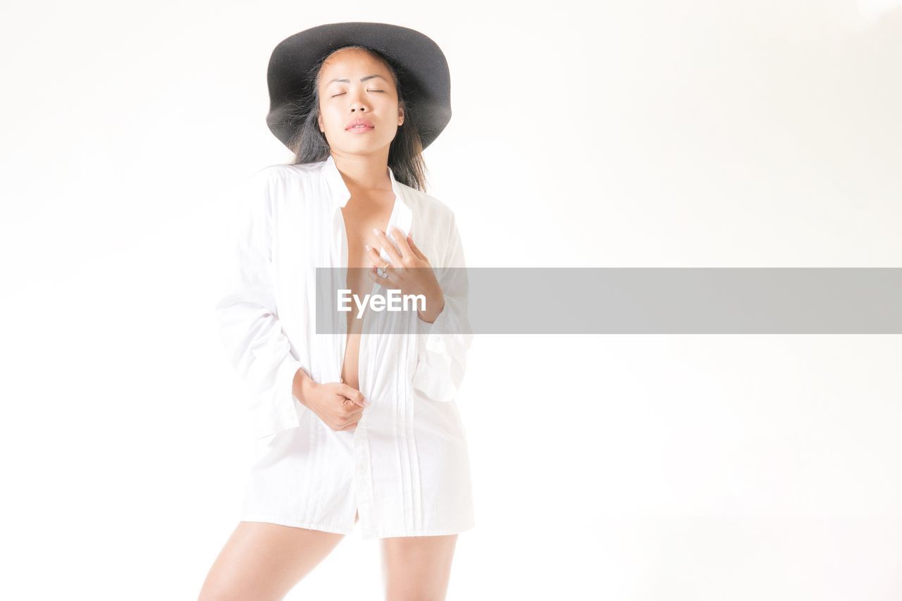 Beautiful woman standing against white background