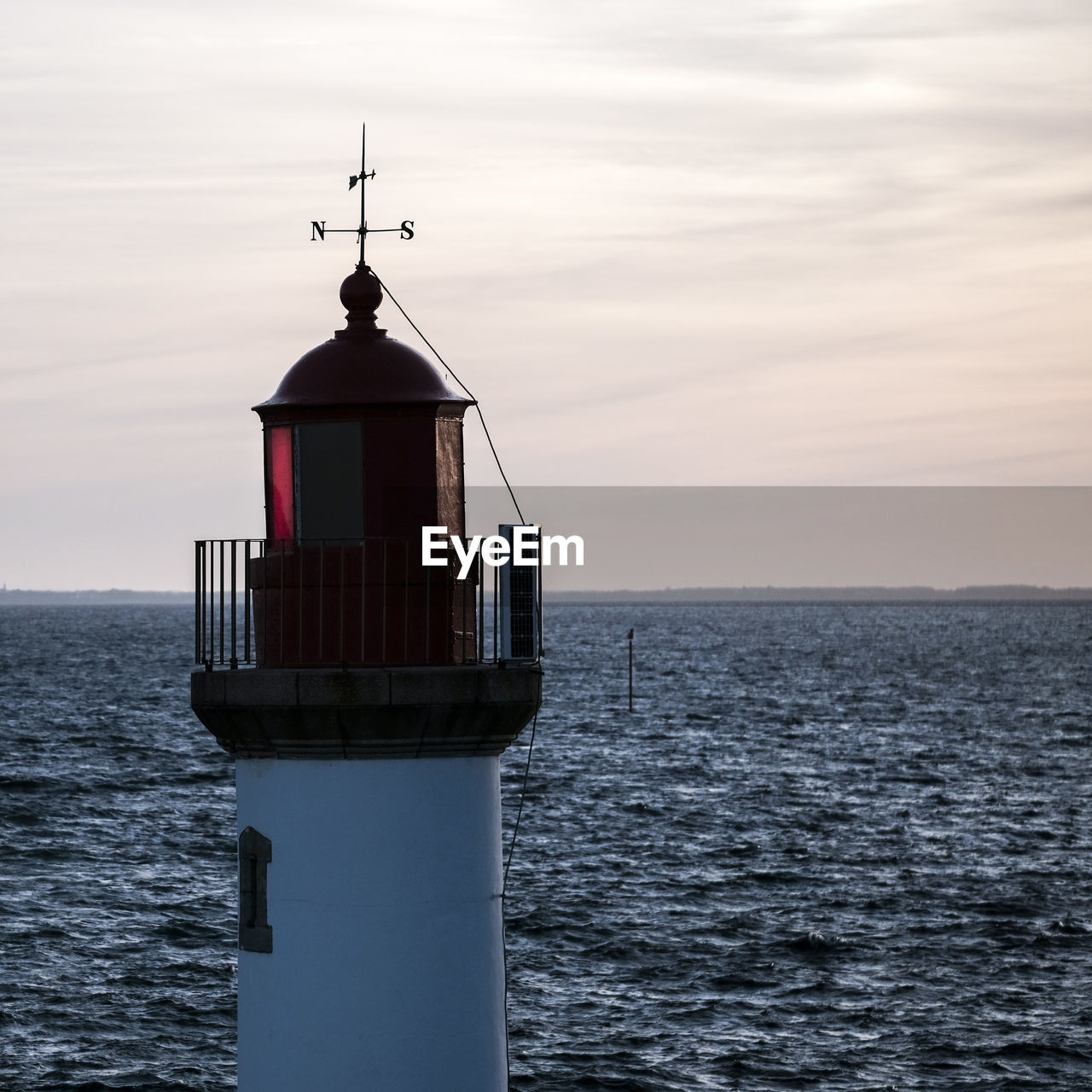 LIGHTHOUSE ON SEA AGAINST SKY