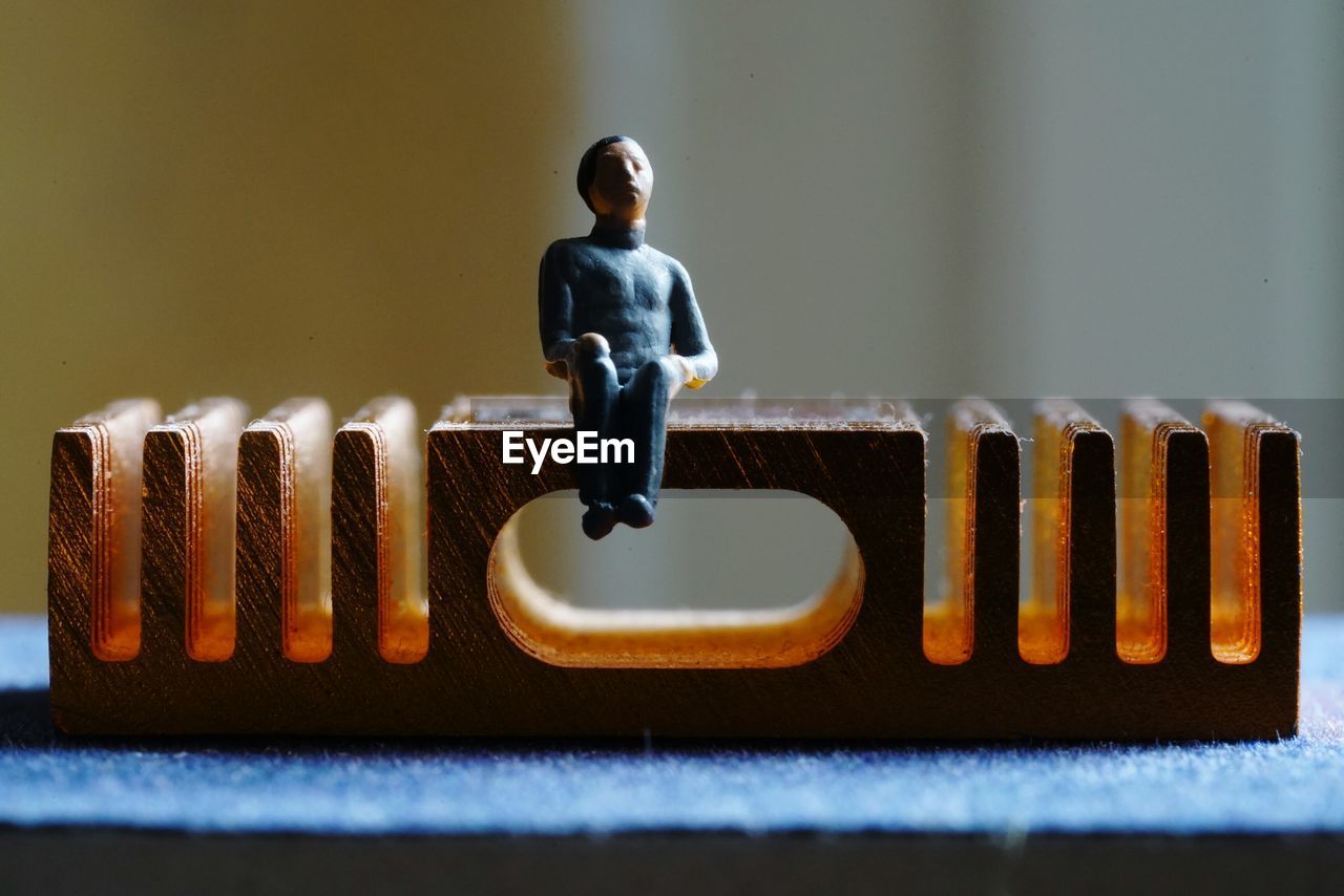 Close-up of figurine on wood