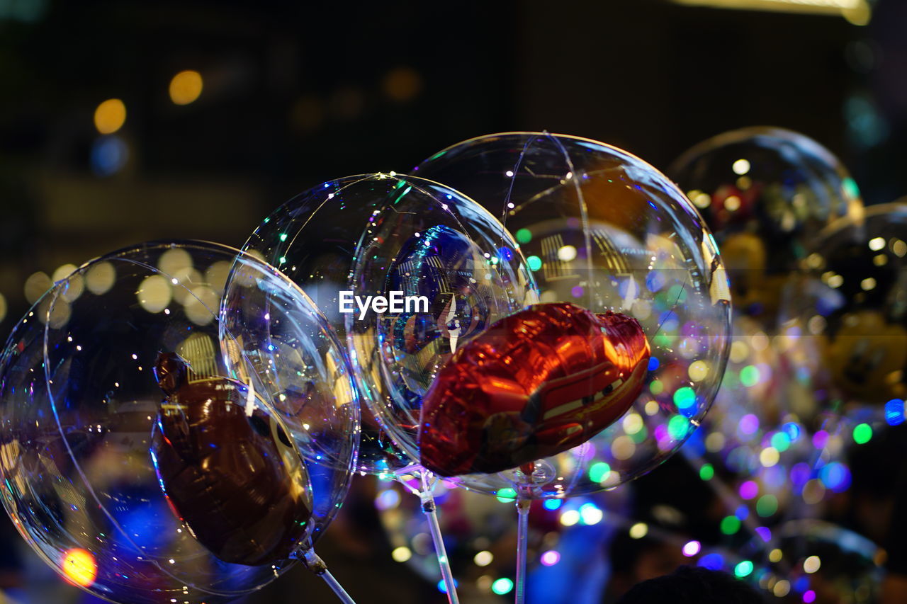 CLOSE-UP OF ILLUMINATED BUBBLES IN GLASS