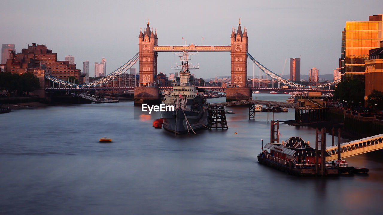Boat on thames river against tower bridge in city