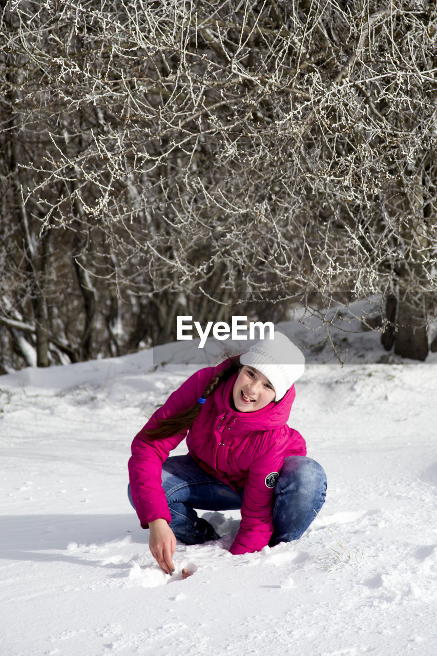 Full length portrait of a girl in snow