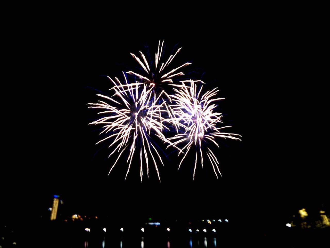 LOW ANGLE VIEW OF FIREWORKS EXPLODING IN SKY