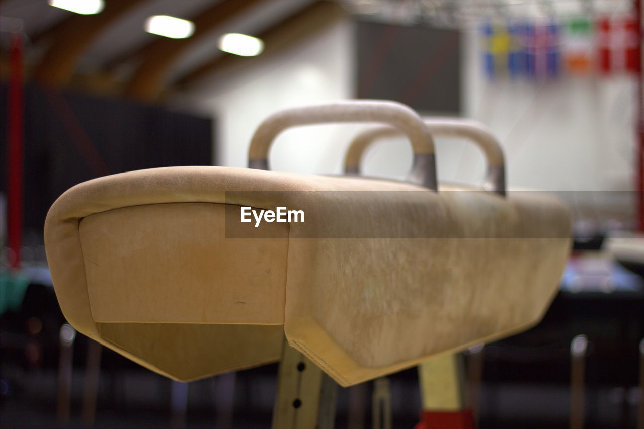 CLOSE-UP OF EMPTY CHAIR IN BUILDING