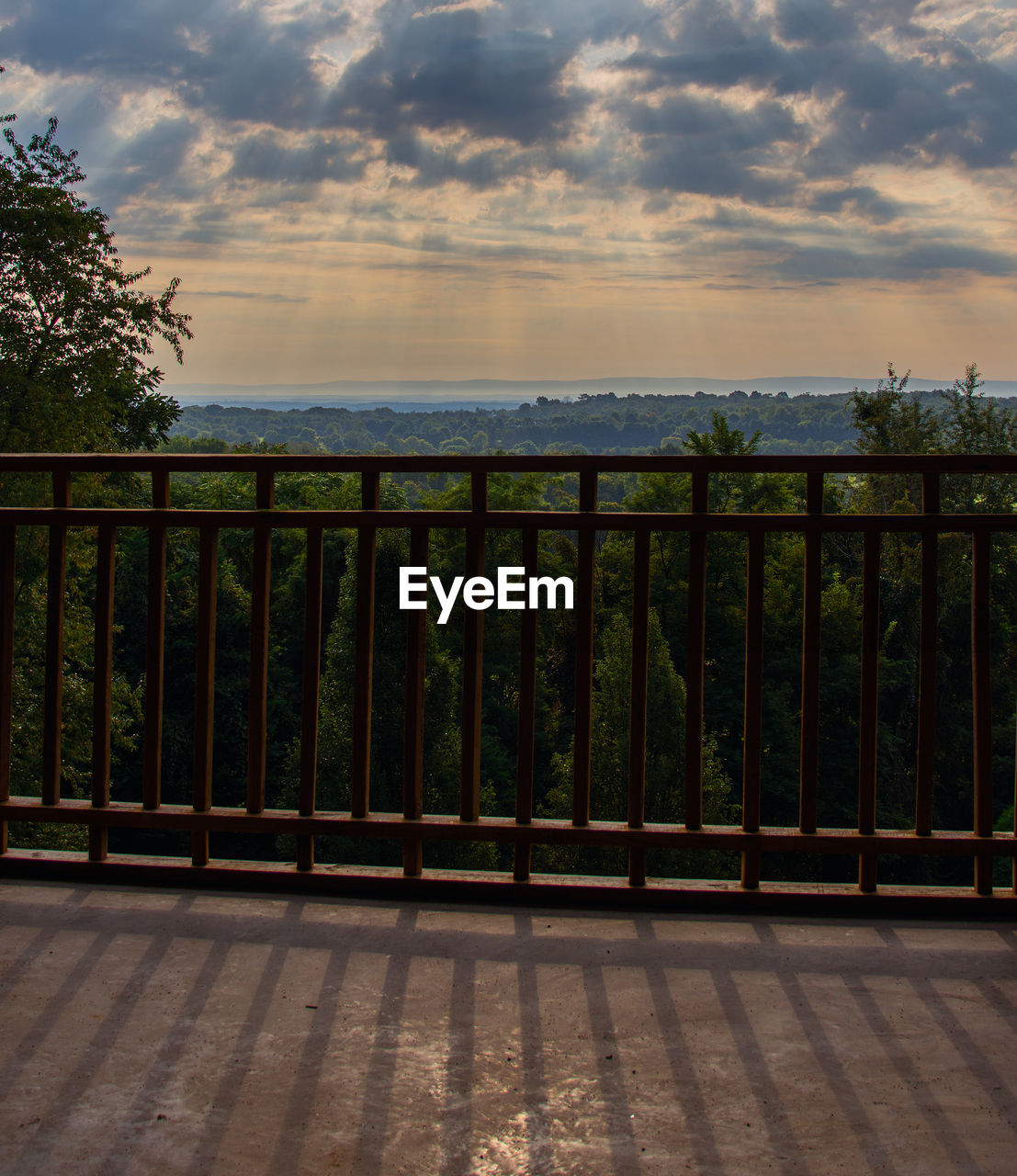 RAILING BY SEA AGAINST SKY DURING SUNSET