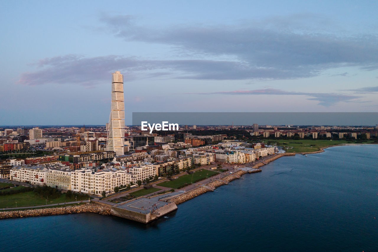 Aerial view of modern skyline in malmo city against sky during sunset