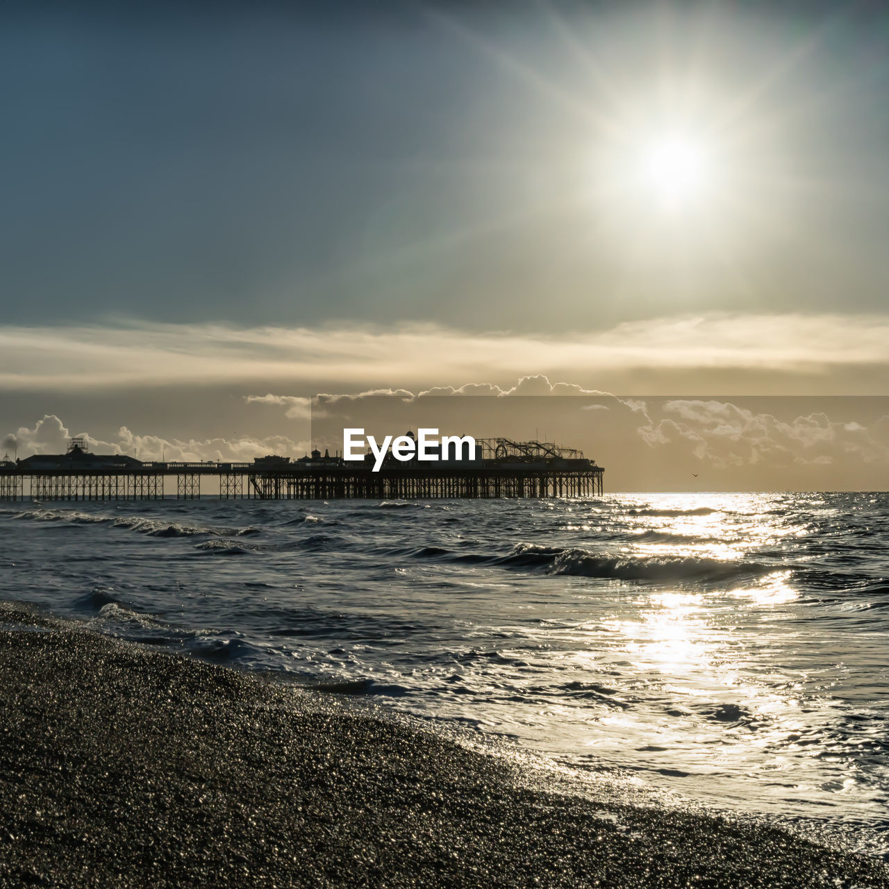 Scenic view of sea and pier against sky during sunrise