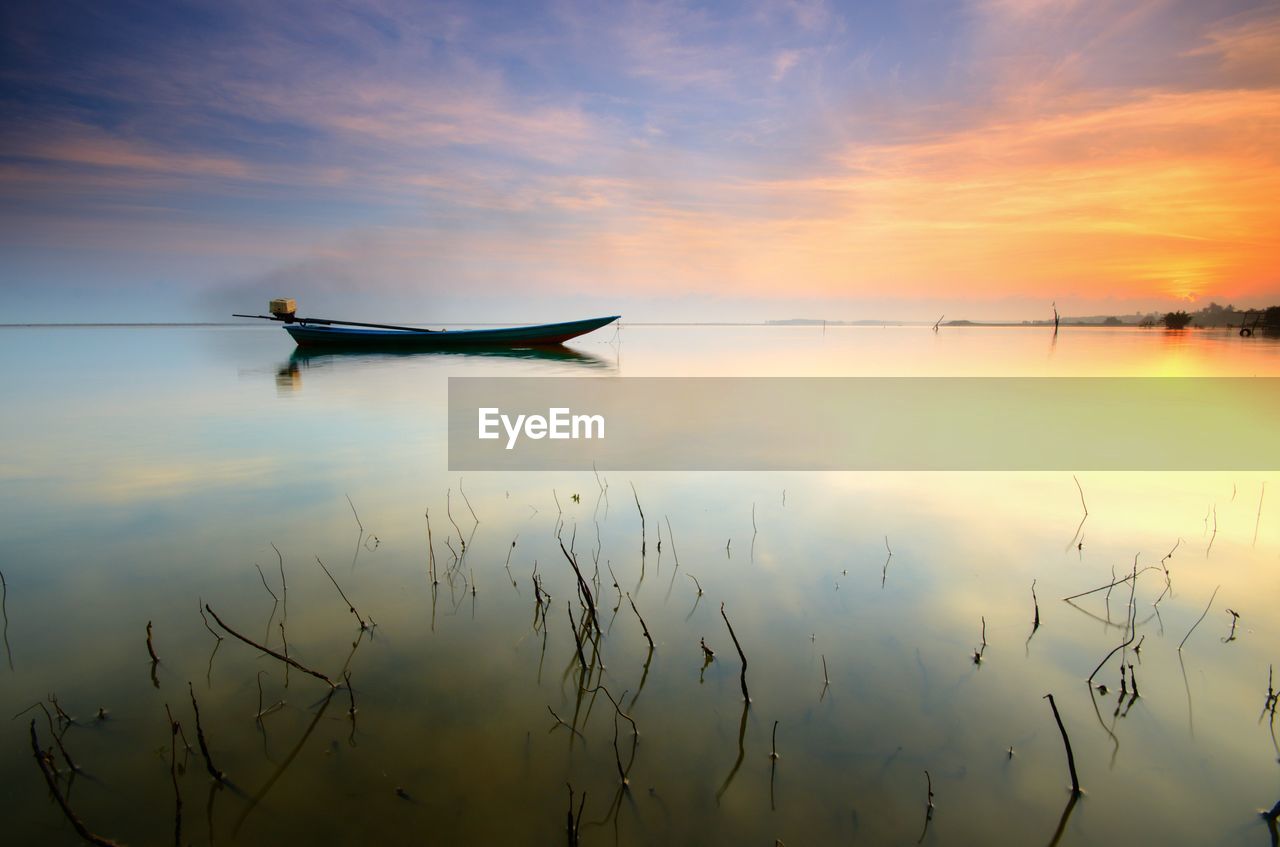 SCENIC VIEW OF LAKE AGAINST ORANGE SKY