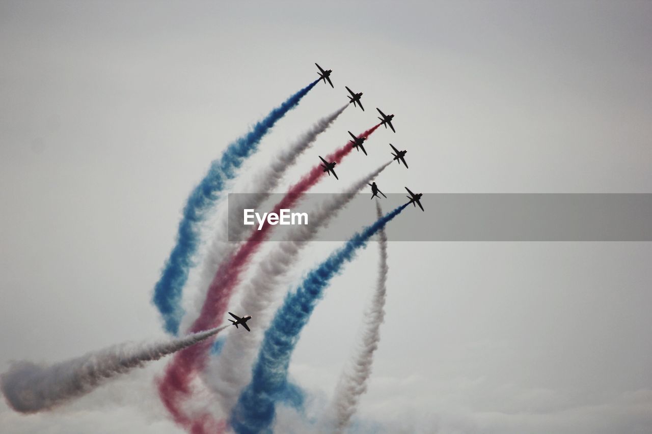 Low angle view of airshow against clear sky