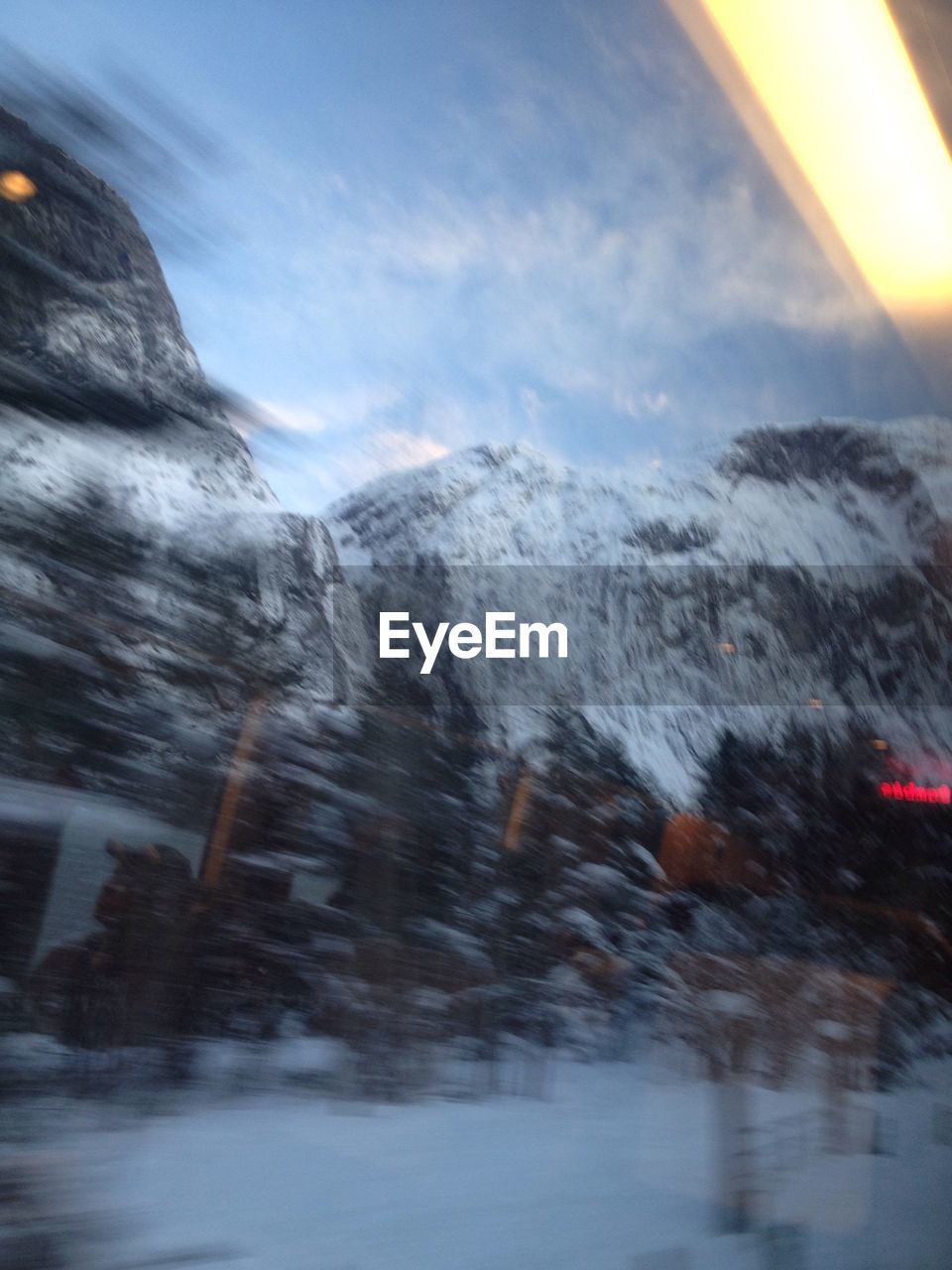 CLOSE-UP OF SNOW COVERED MOUNTAIN AGAINST SKY