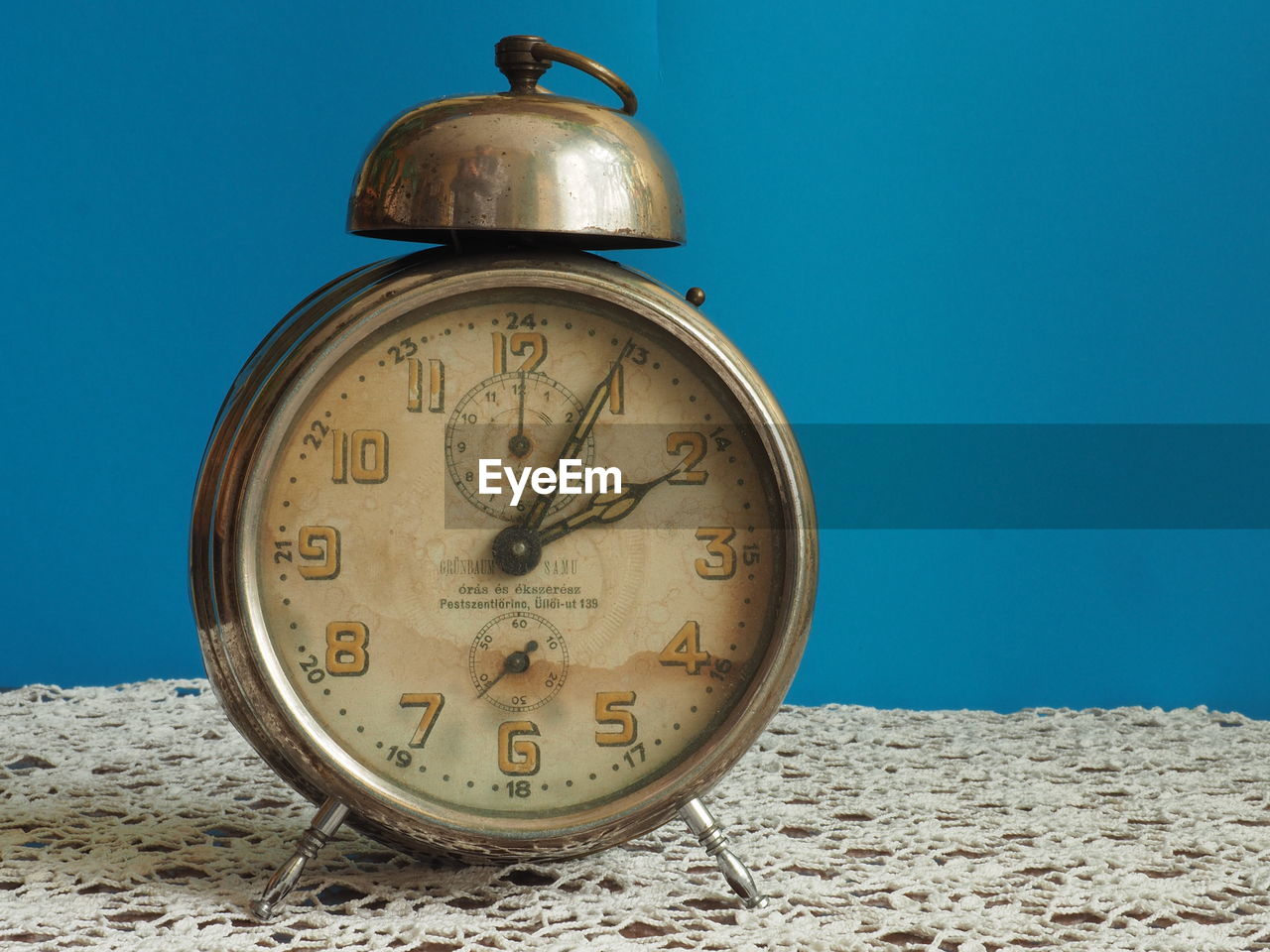 CLOSE-UP OF CLOCK ON THE SAND