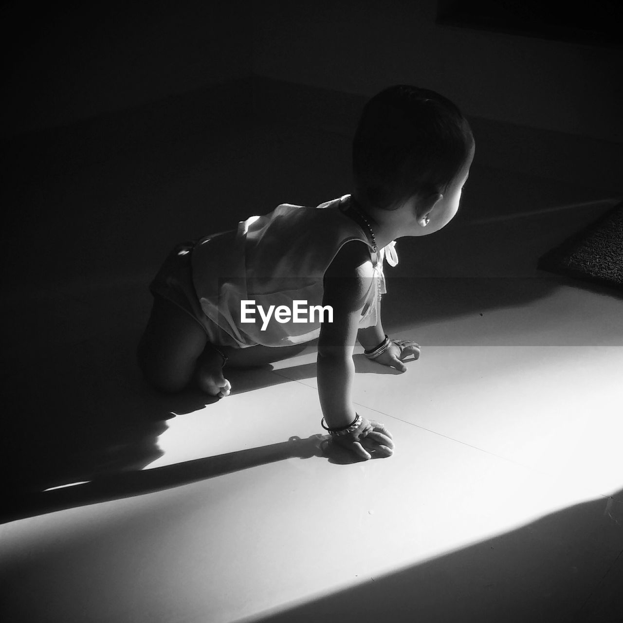 High angle view of child crawling on floor at home