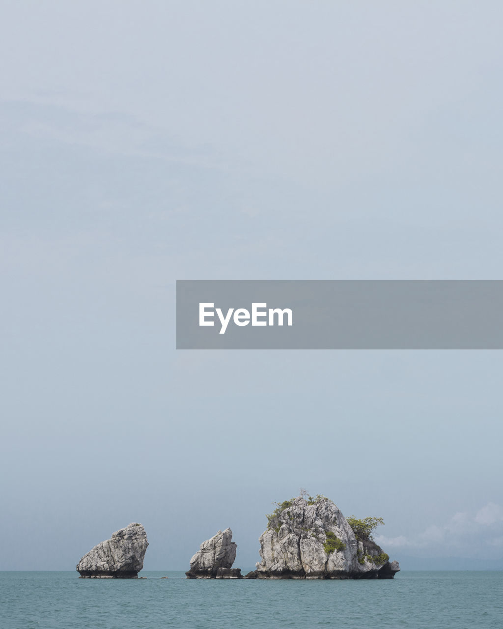 Scenic view of rock formation in sea against sky