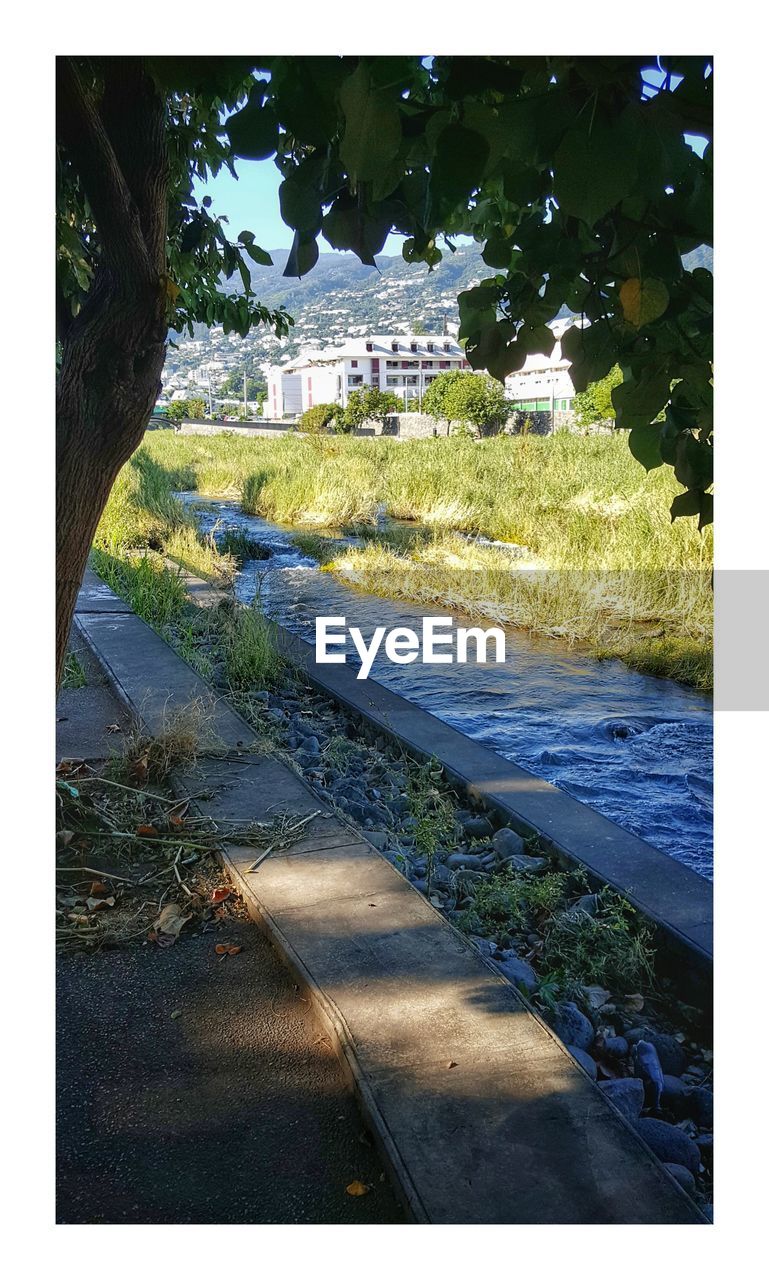 VIEW OF LANDSCAPE WITH WATER IN FOREGROUND