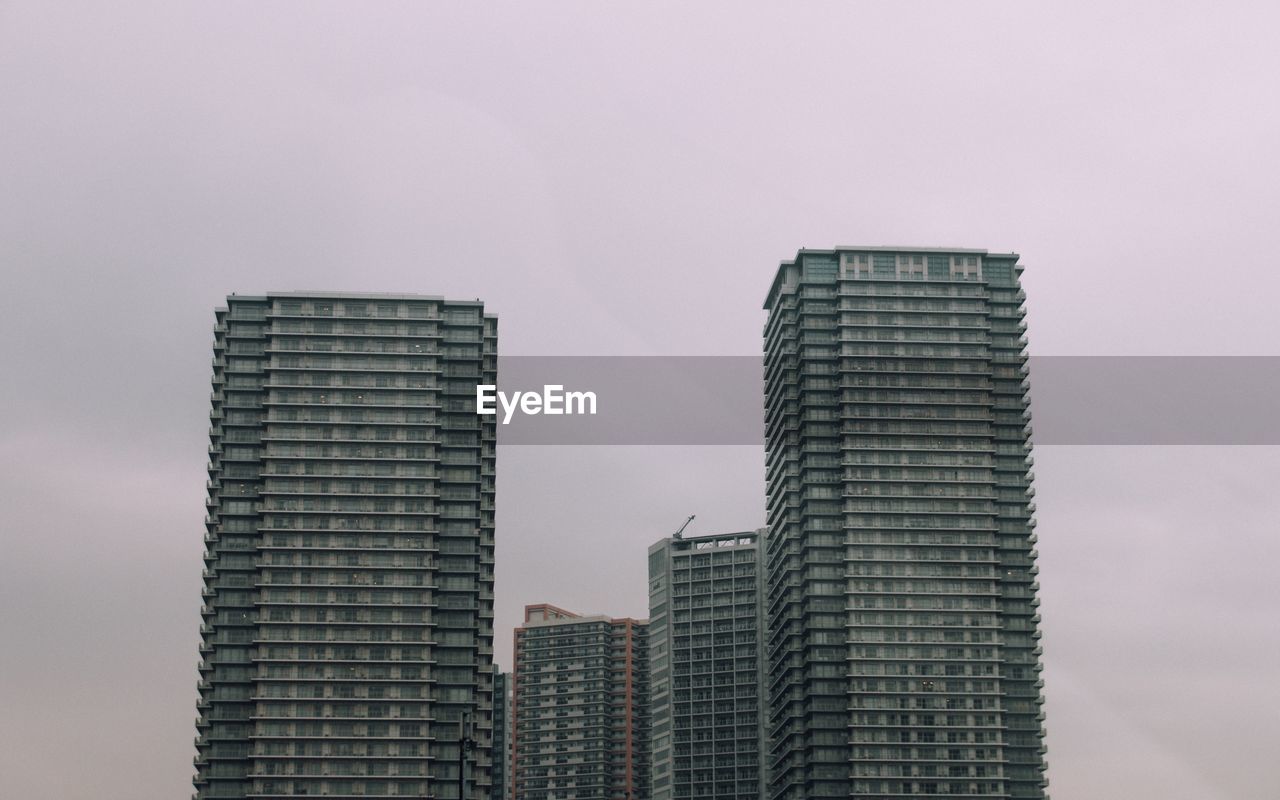 Low angle view of buildings against sky in city