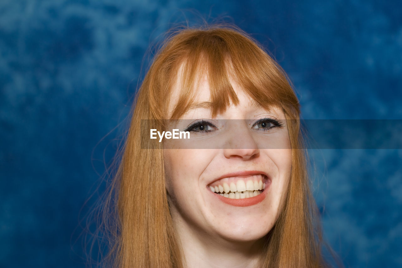 Close-up portrait of smiling young woman