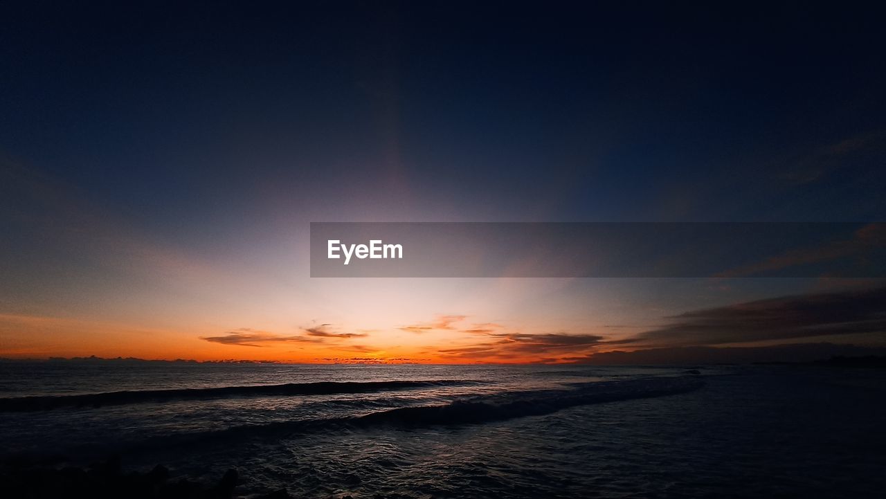 scenic view of sea against sky at sunset