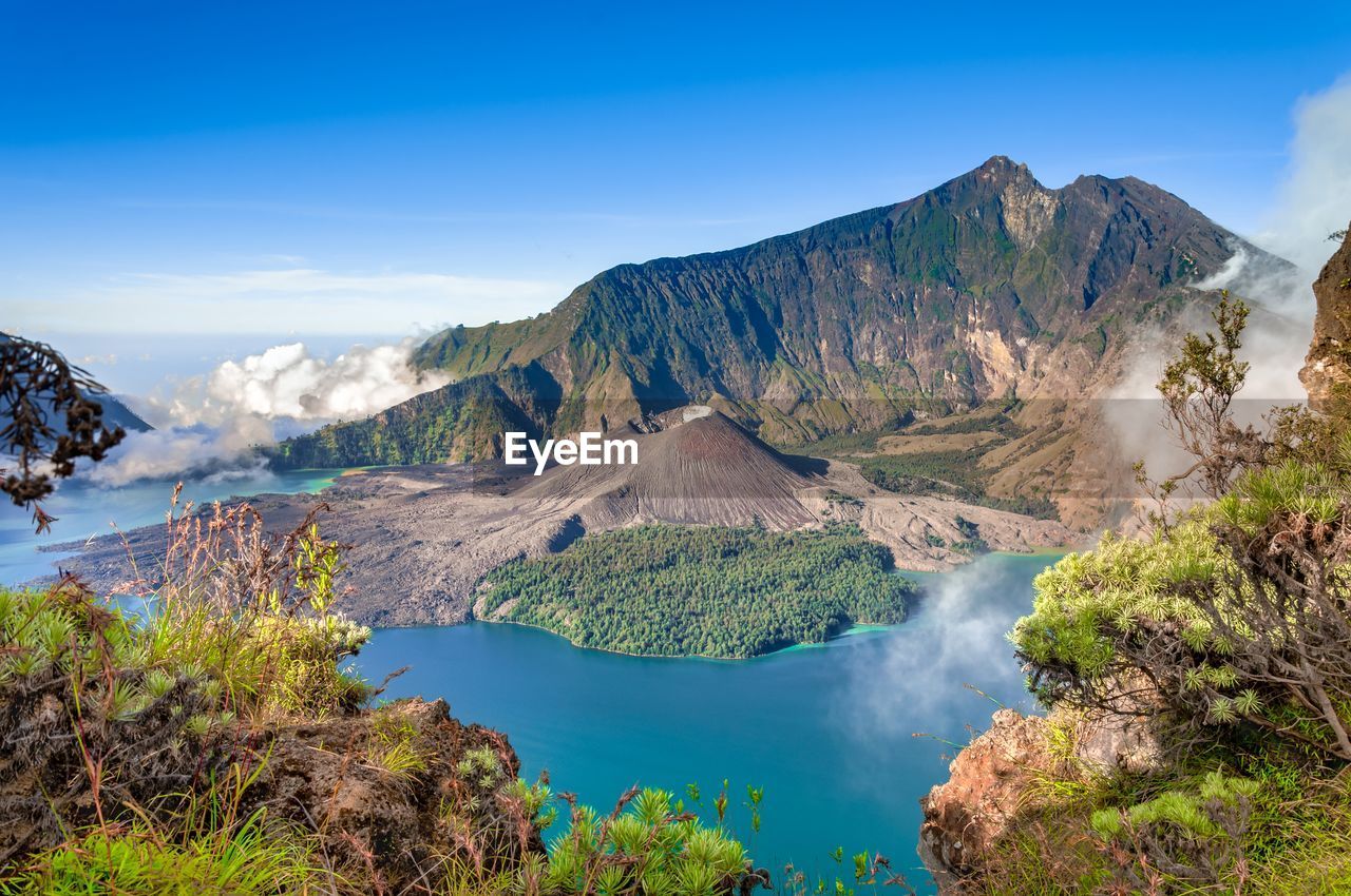 Scenic view of mountains against blue sky