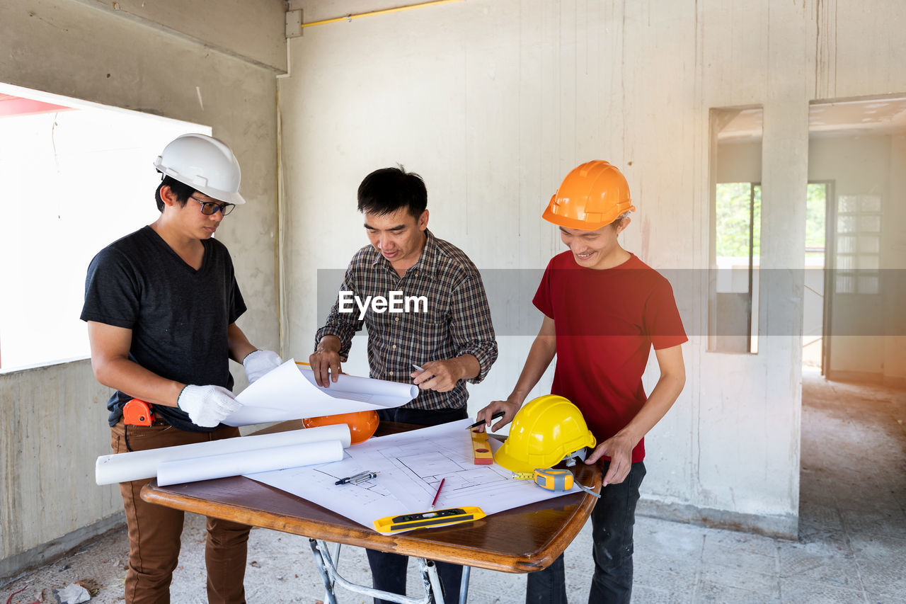 side view of man working at table