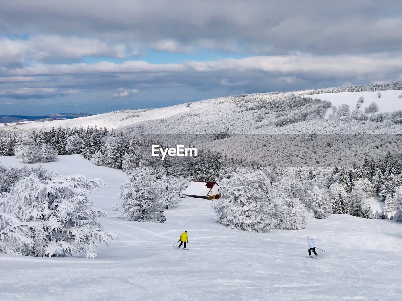 People on snowcapped mountain against sky