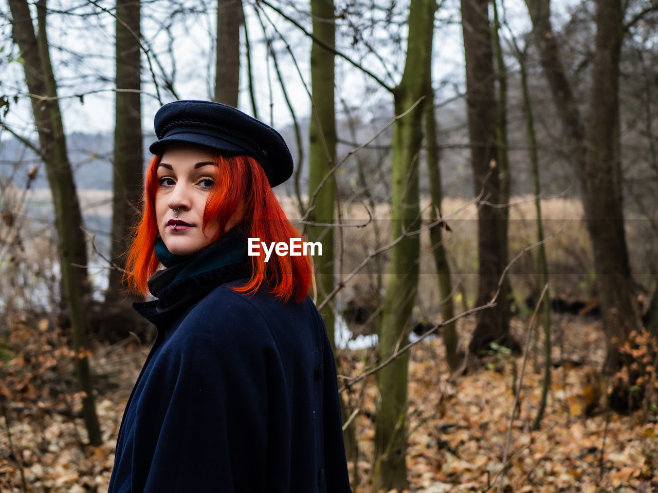 Portrait of young redhead woman in forest