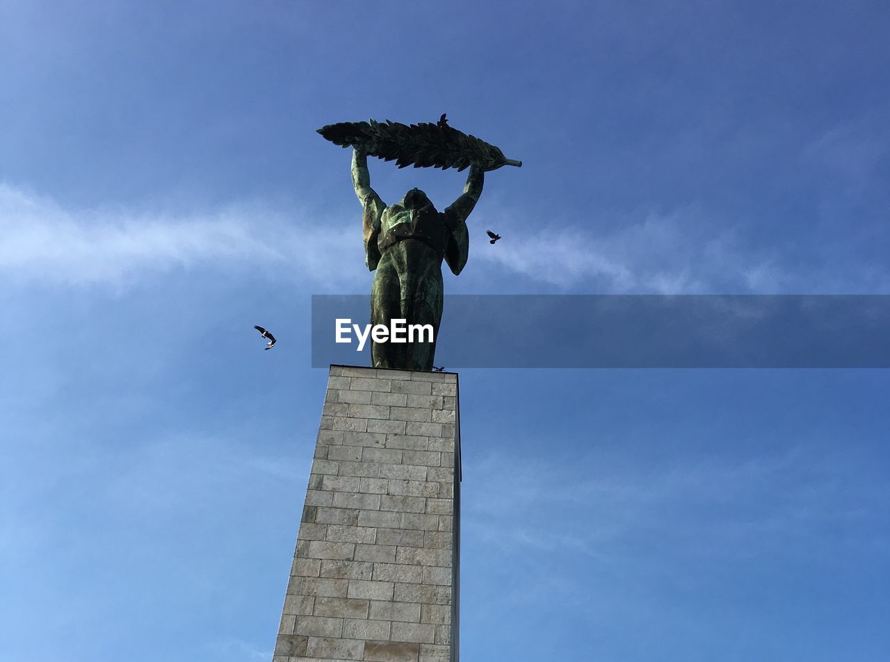 Low angle view of statue against sky
