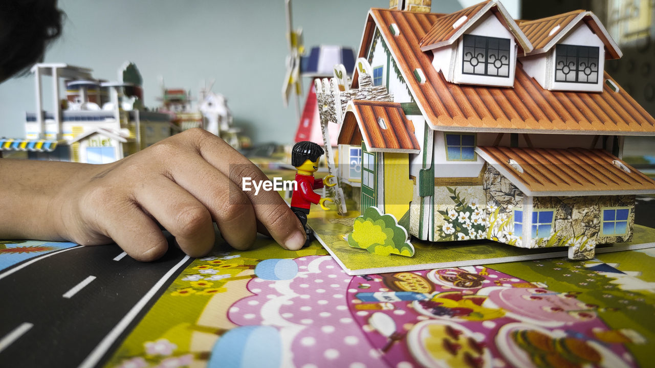 hand, creativity, occupation, one person, art, toy, adult, craft, indoors, skill, working, business finance and industry, drawing, holding, person, business, selective focus, men, industry