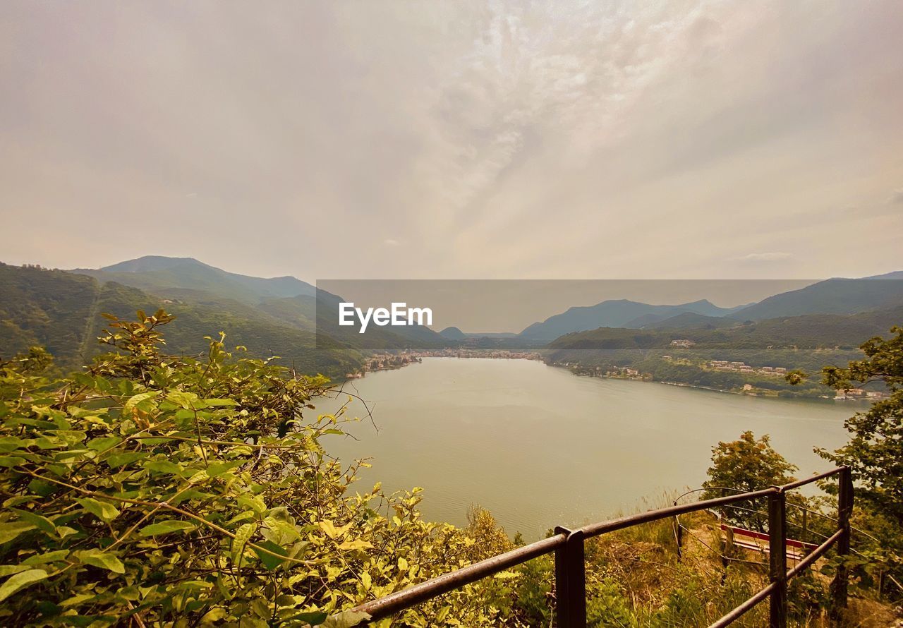 SCENIC VIEW OF MOUNTAINS AND SEA AGAINST SKY