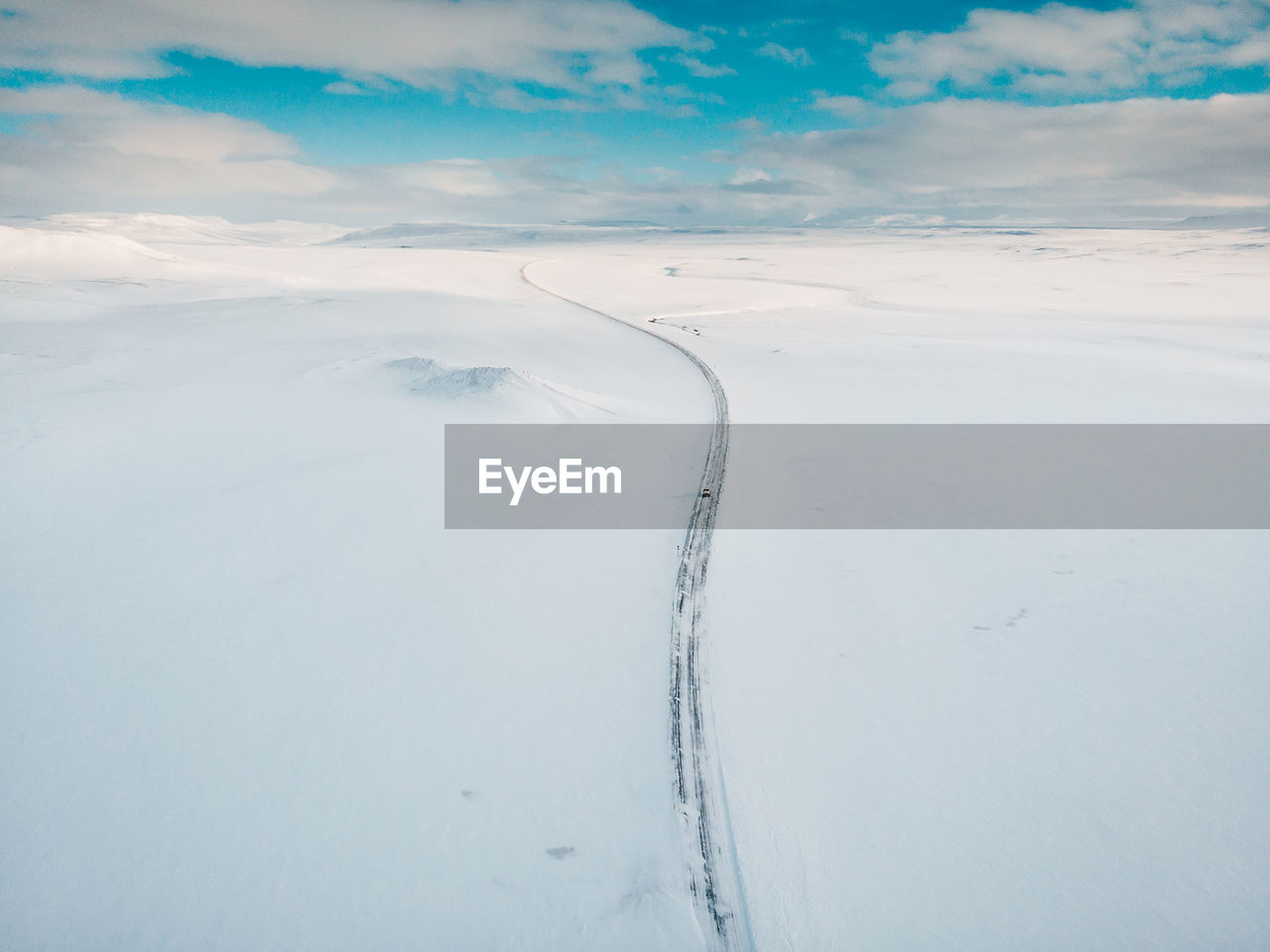 Snow covered land against sky