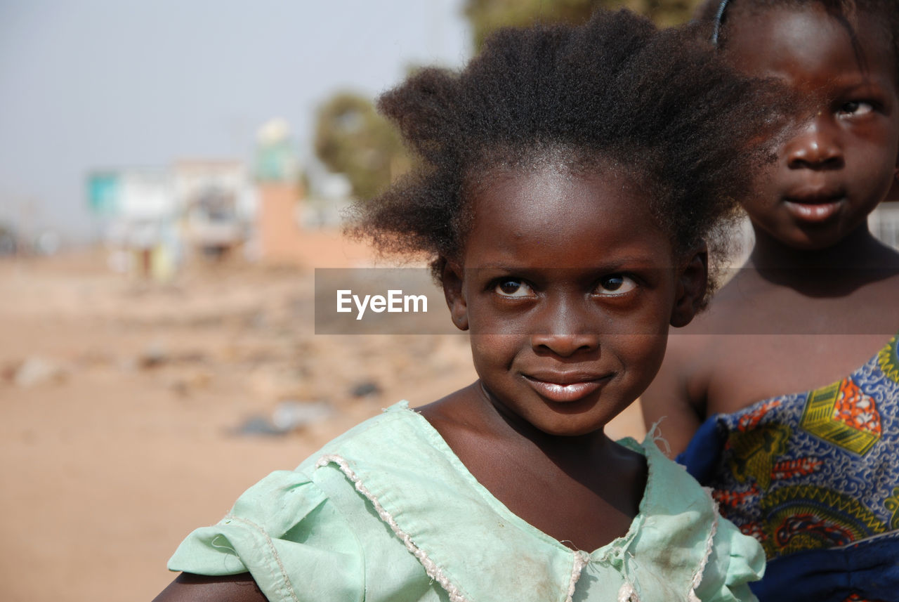 Close-up of girl looking away while standing outdoors