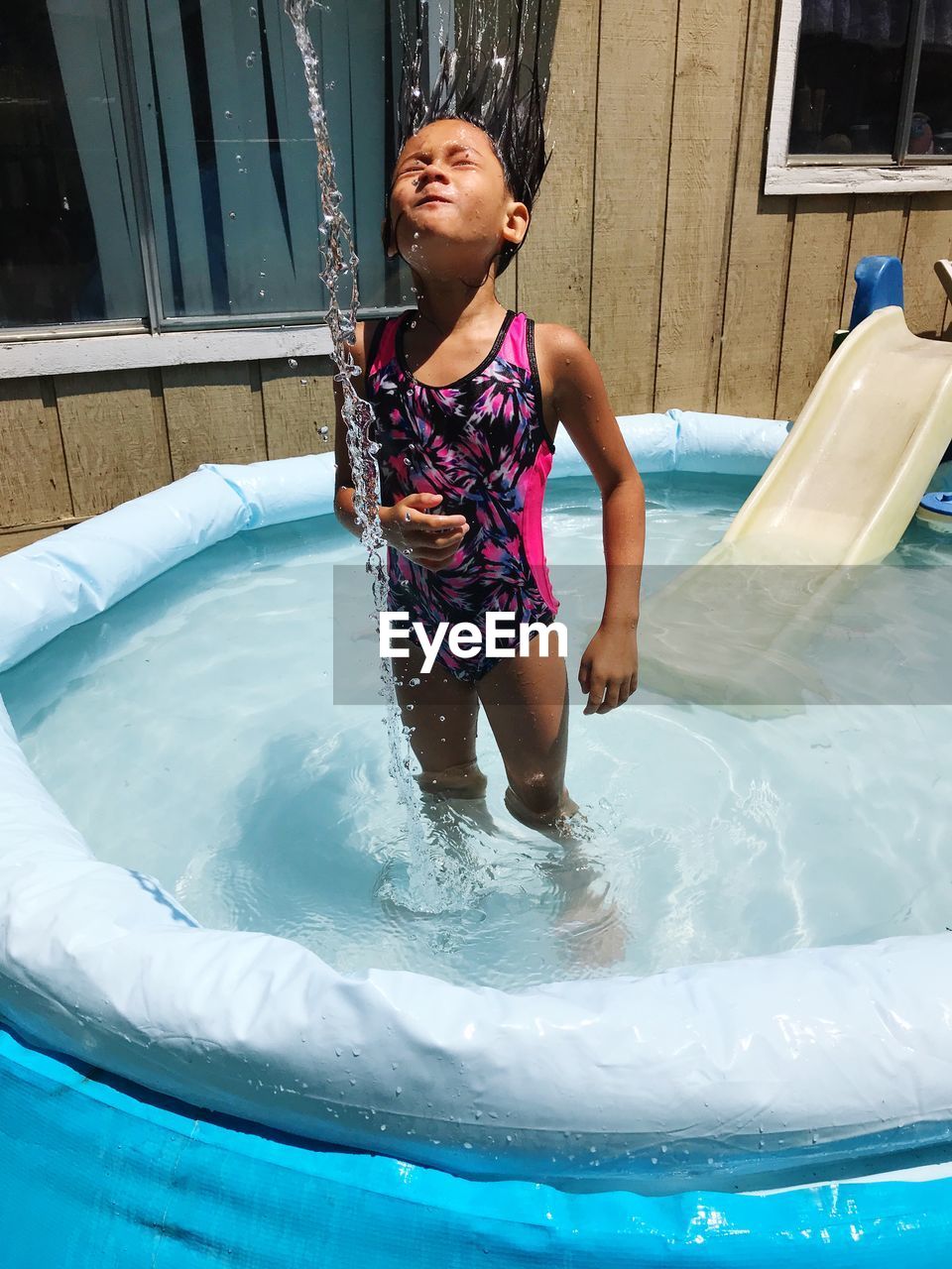 Full length of girl in wading pool