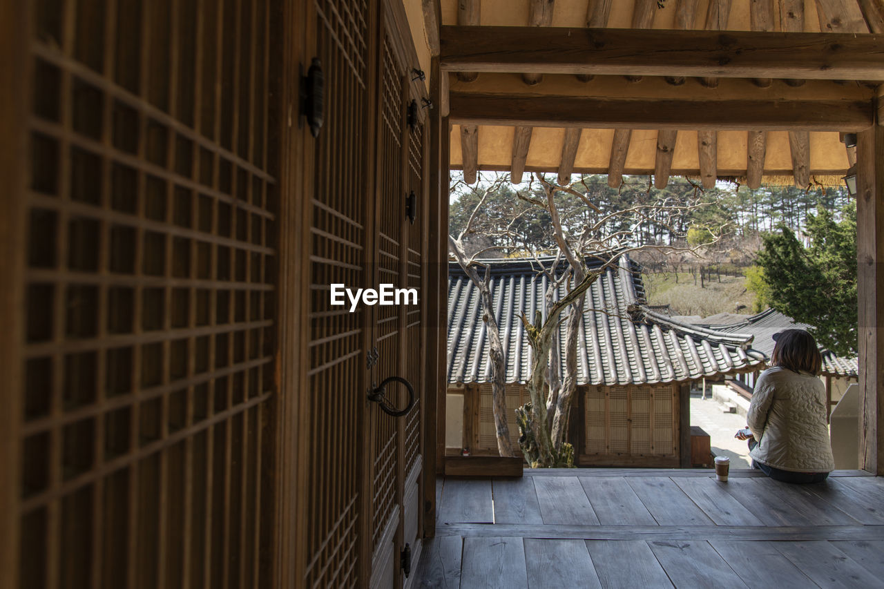 Woman sitting on the terrace of old korean traditional house. 