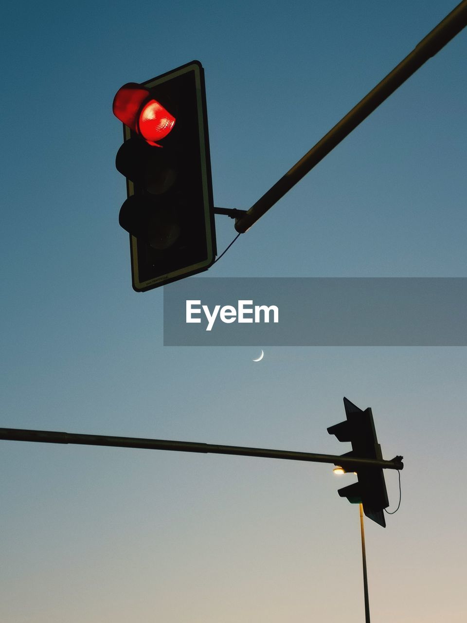 Low angle view of road signal against clear sky