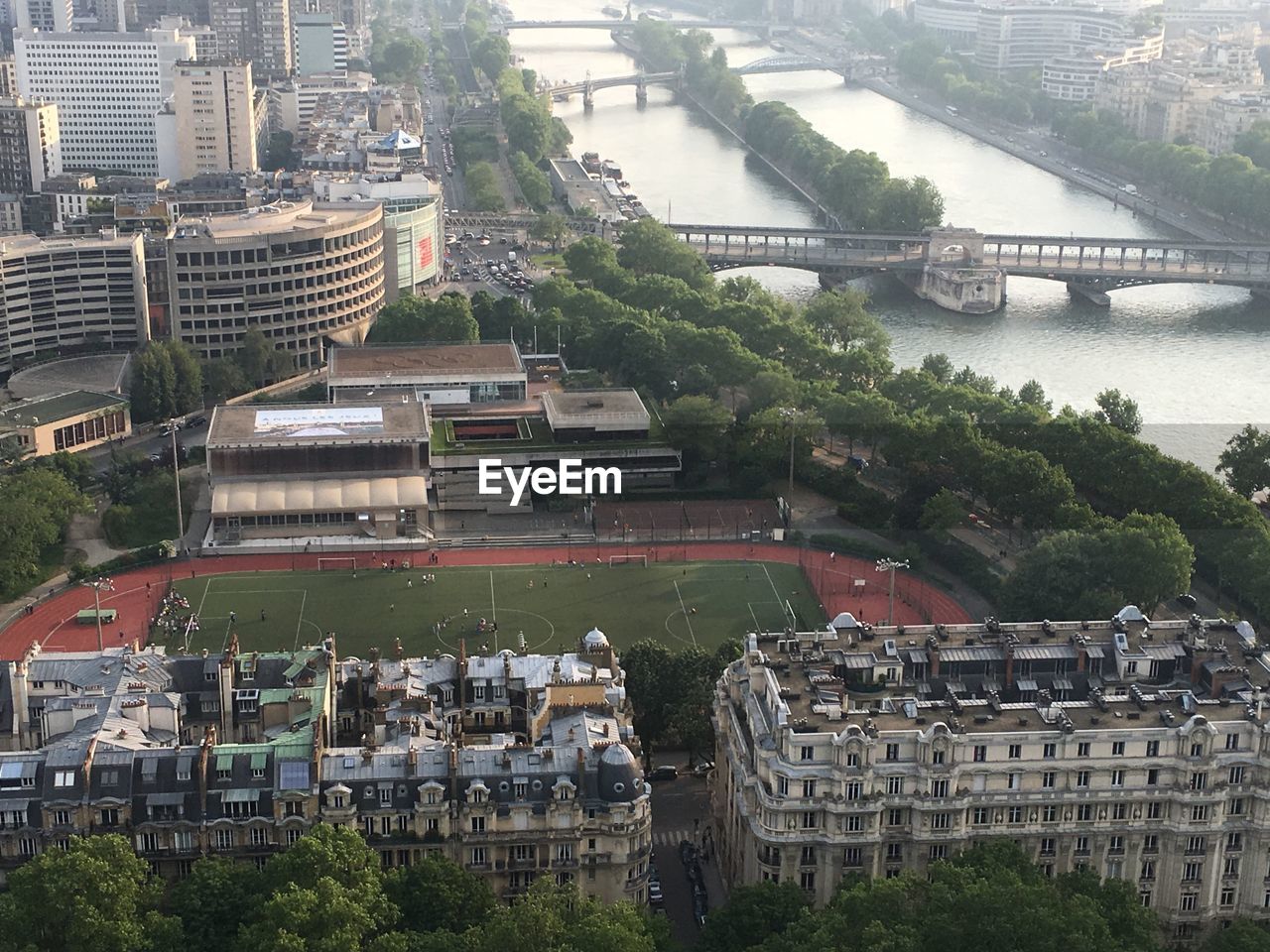 HIGH ANGLE VIEW OF RIVER AMIDST BUILDINGS IN CITY