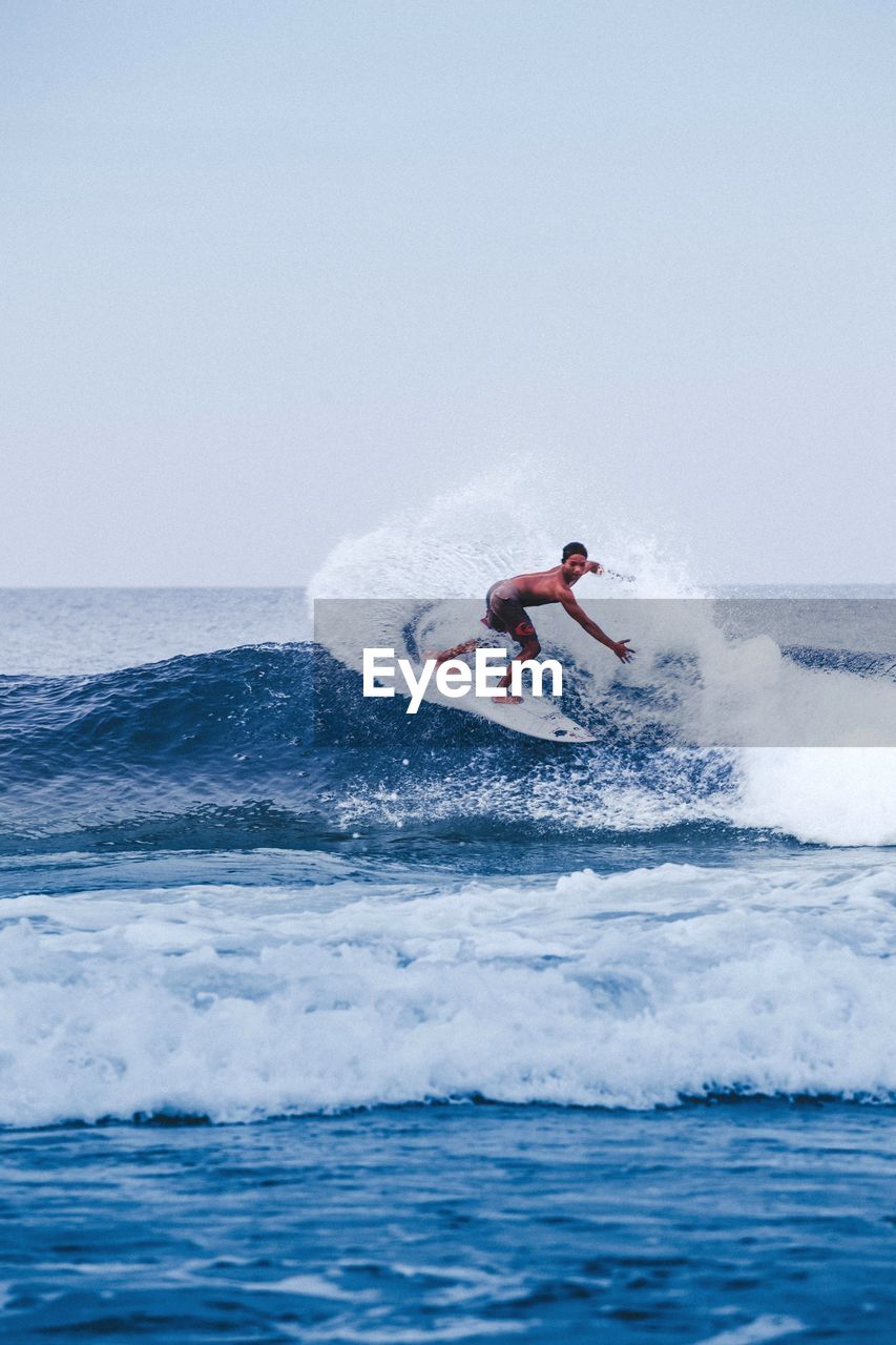 MAN SURFING IN SEA