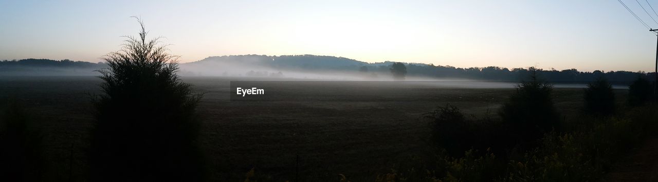 Scenic view of field against sky during sunrise