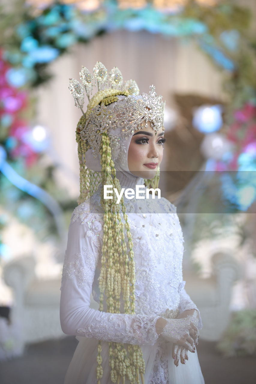 Beautiful bride looking away at wedding ceremony