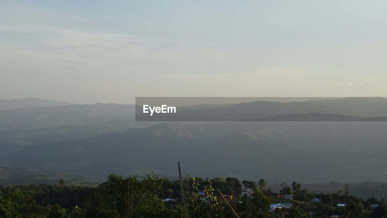 SCENIC VIEW OF TREE MOUNTAINS AGAINST SKY