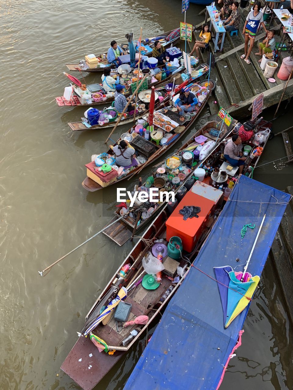 High angle view of people in boats on river at floating market