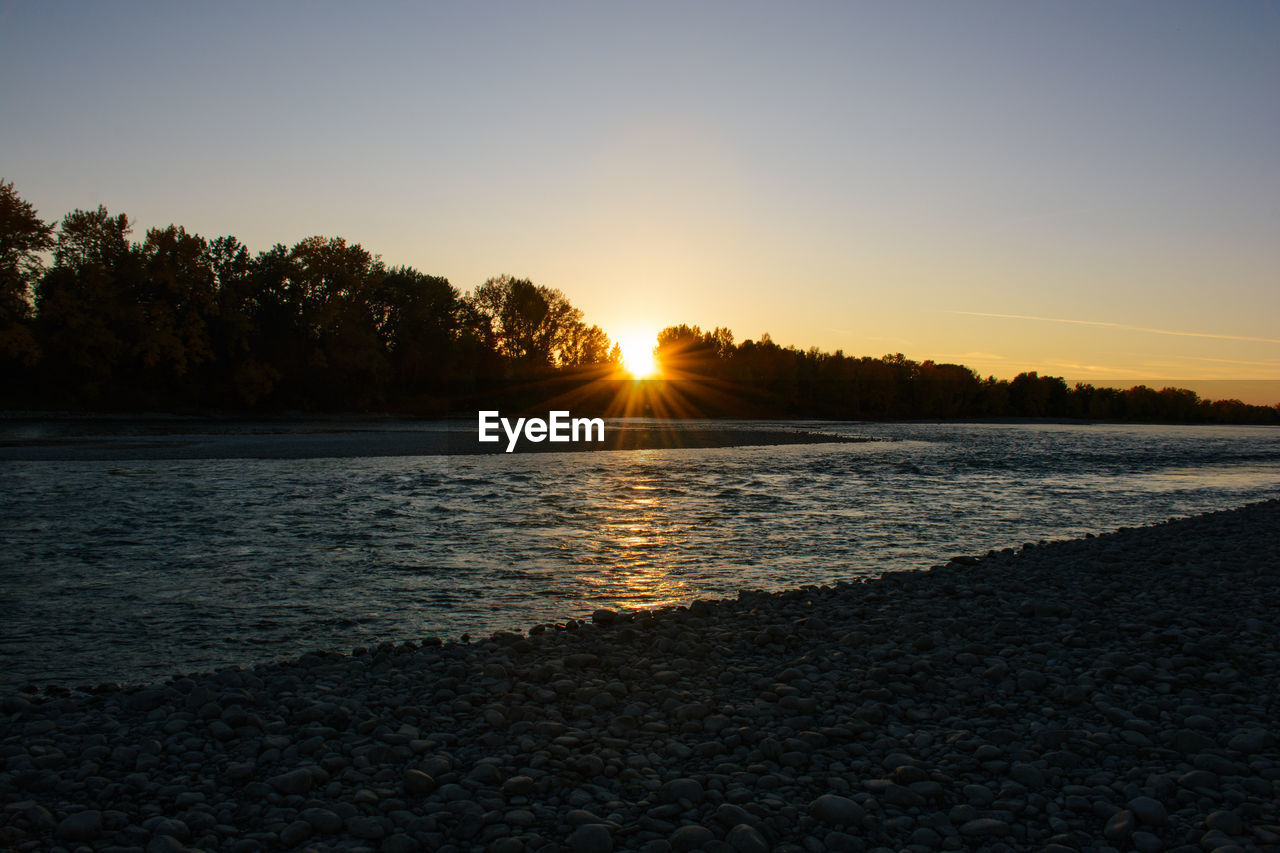 Scenic view of sea against clear sky during sunset