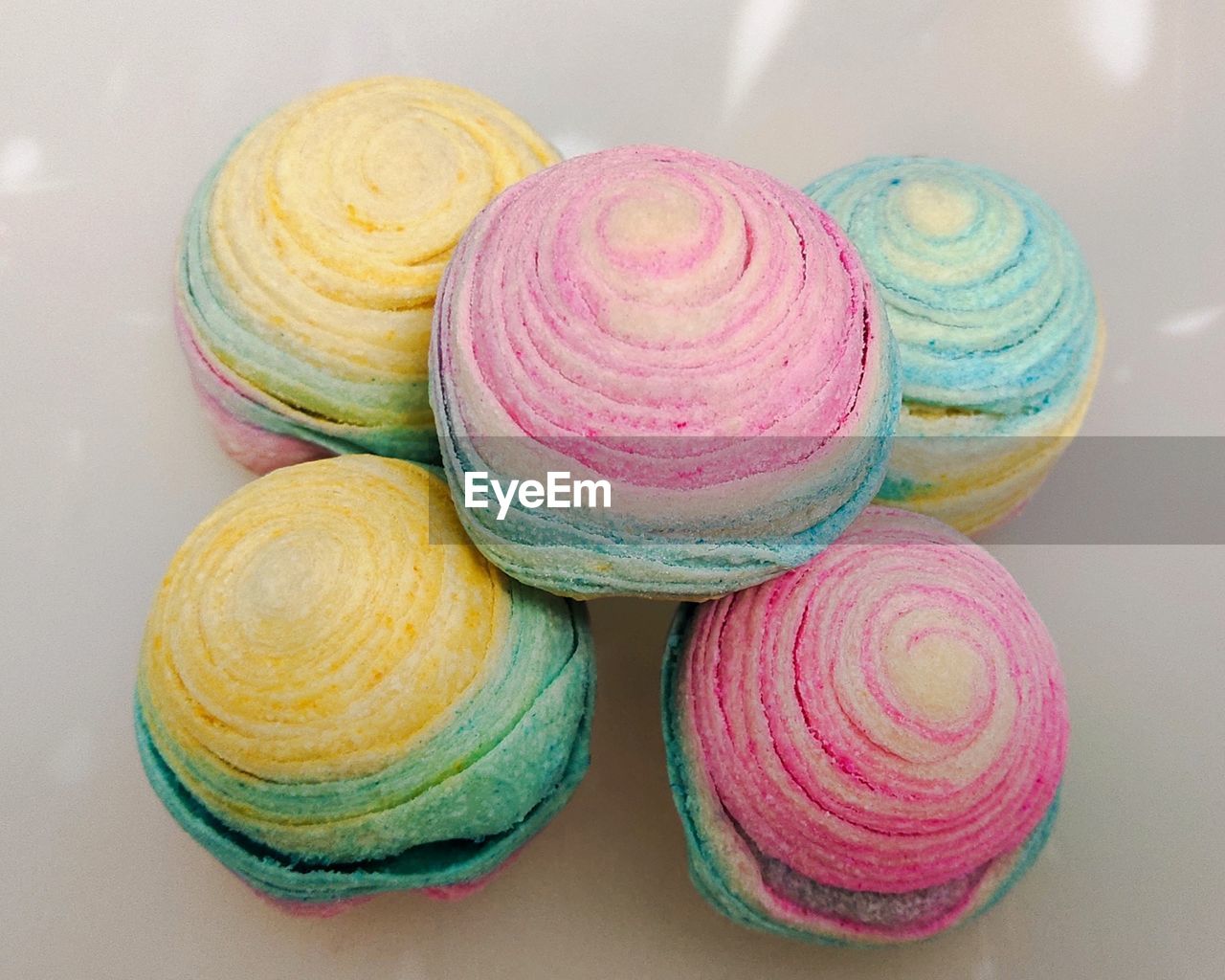 High angle view of multi colored moon cake on table