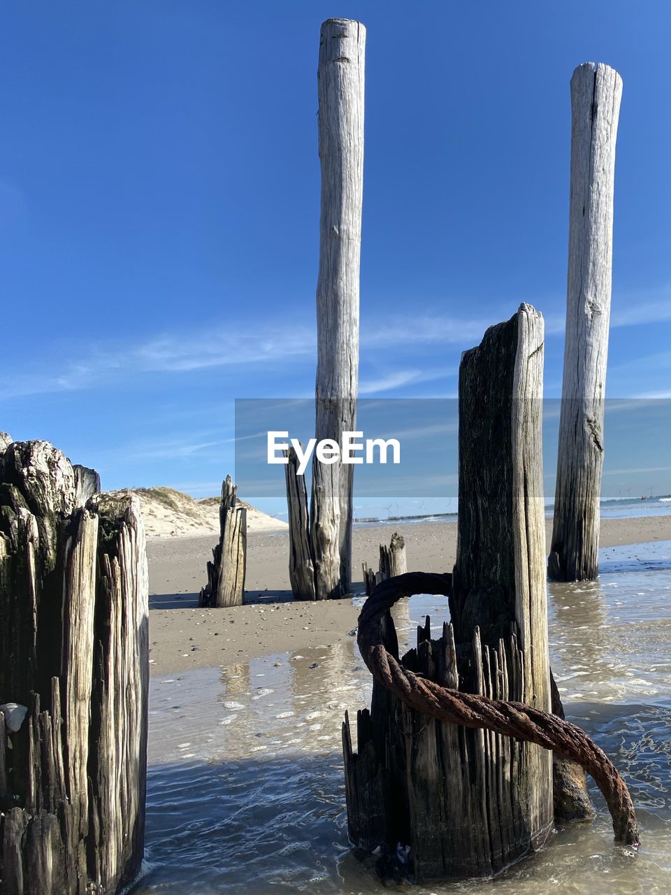 WOODEN POST ON BEACH